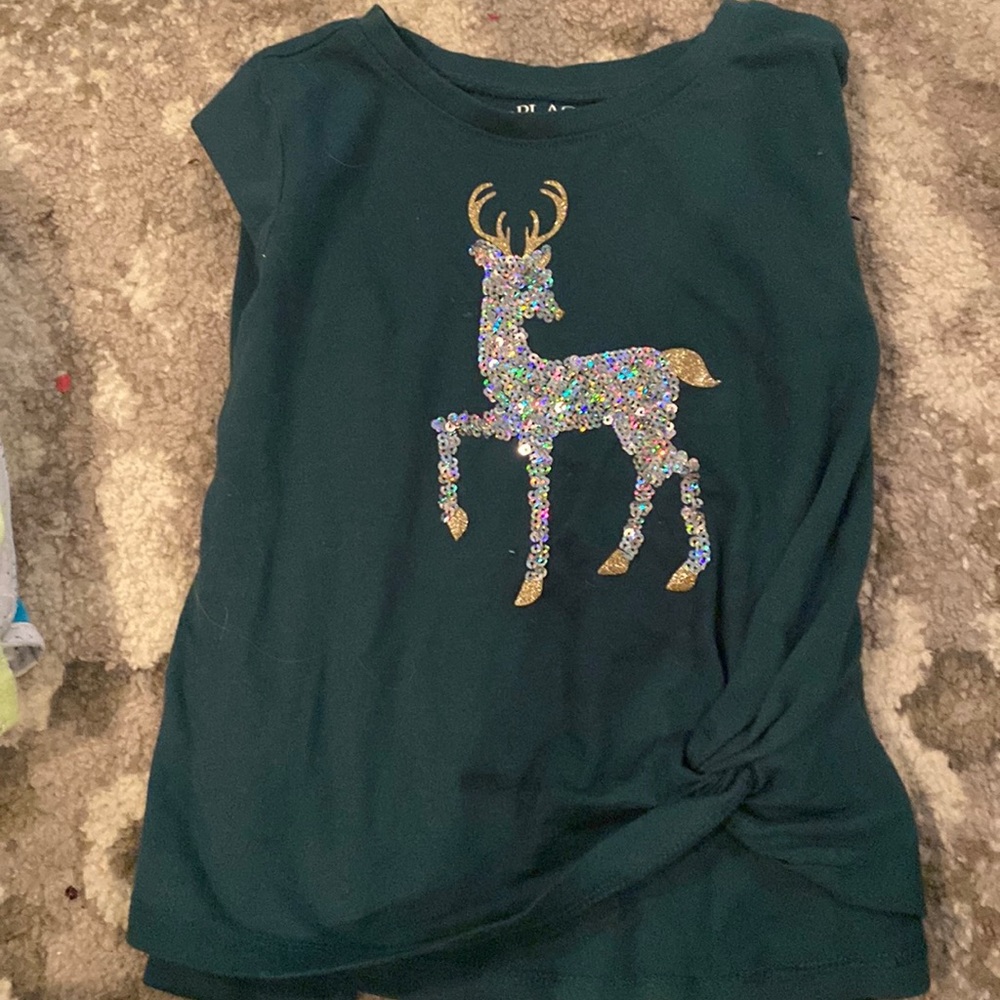 A Children’s place Shirt with a reindeer colored gold and silver